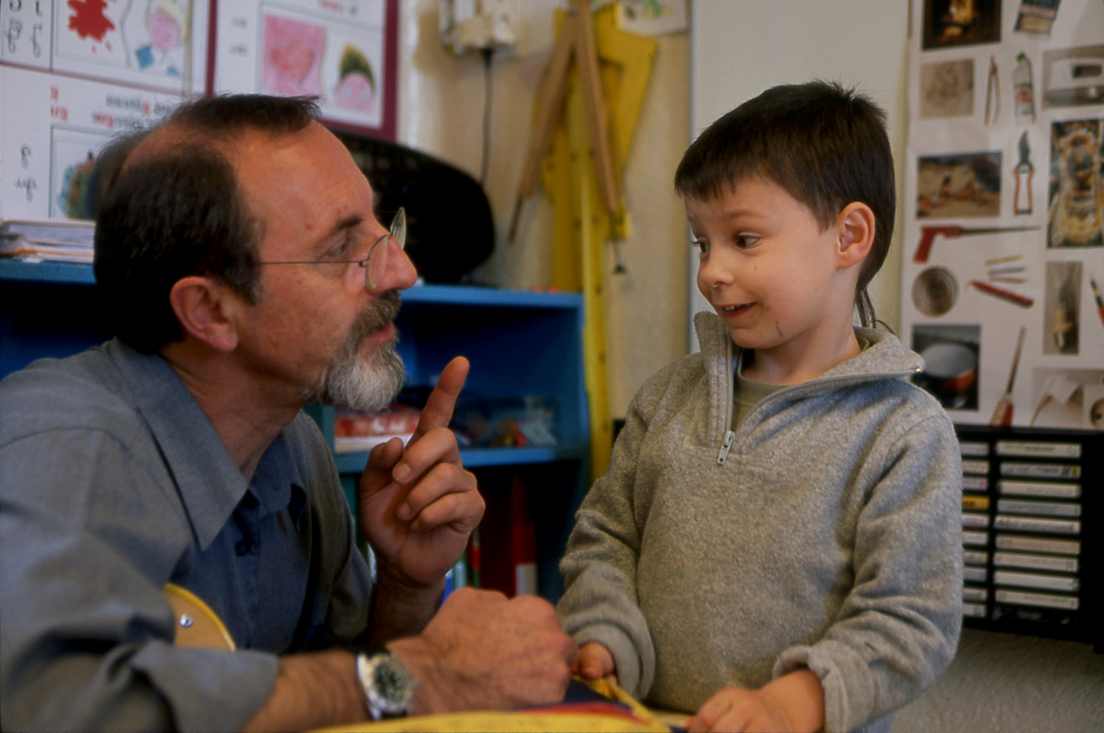 A teacher and a boy in a French kinder garden