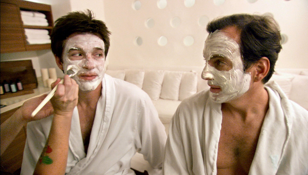 Actors Jason Bateman and Will Arnett talk to each other while someone put facial cream on them