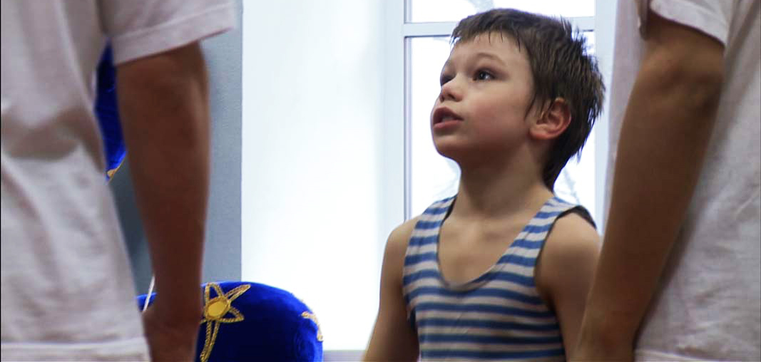 A circus boy talking to his trainer in a circus in Russia