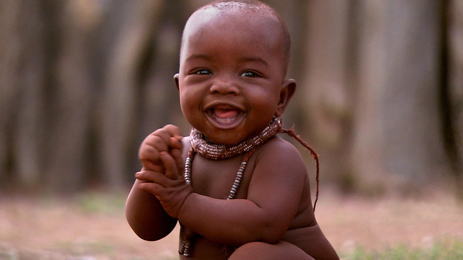 An African baby smiling in the open