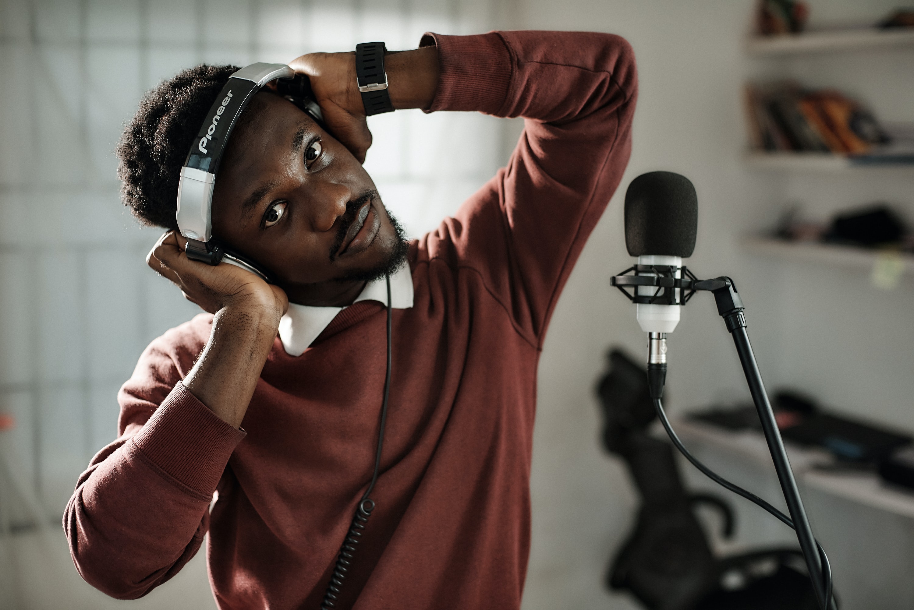 A man leaning his head sideways while wearing headphones 