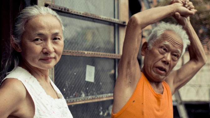 Two old folks playfully posing to the camera