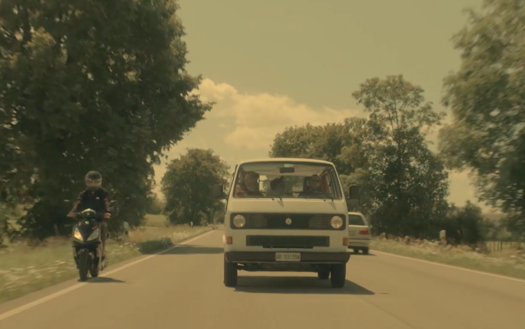 the motorcyclist is driving down the road near the car