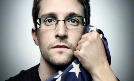 A white man with glasses with a flag in a hand 