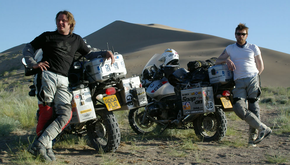 two motorcyclists on the roadside and two motorcycles