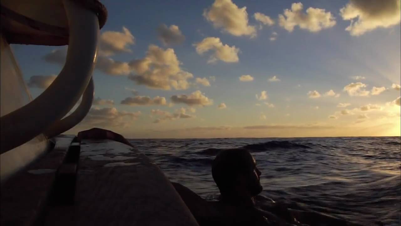 a man near a boat in the sea