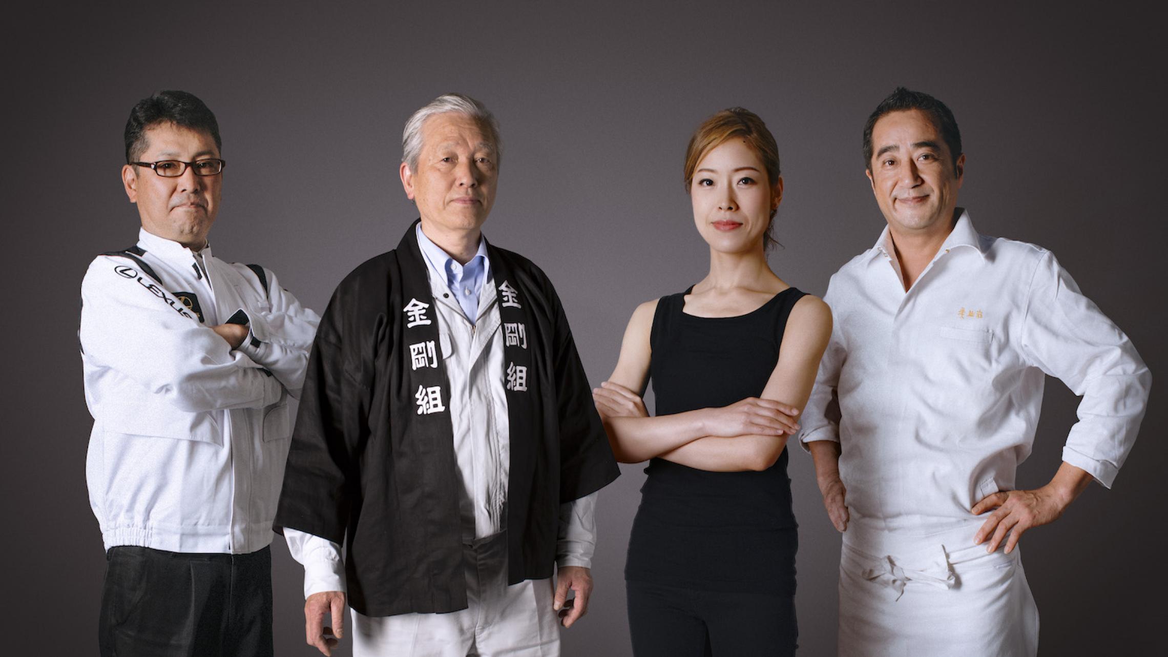 three men and one woman pose in traditional Japanese clothing