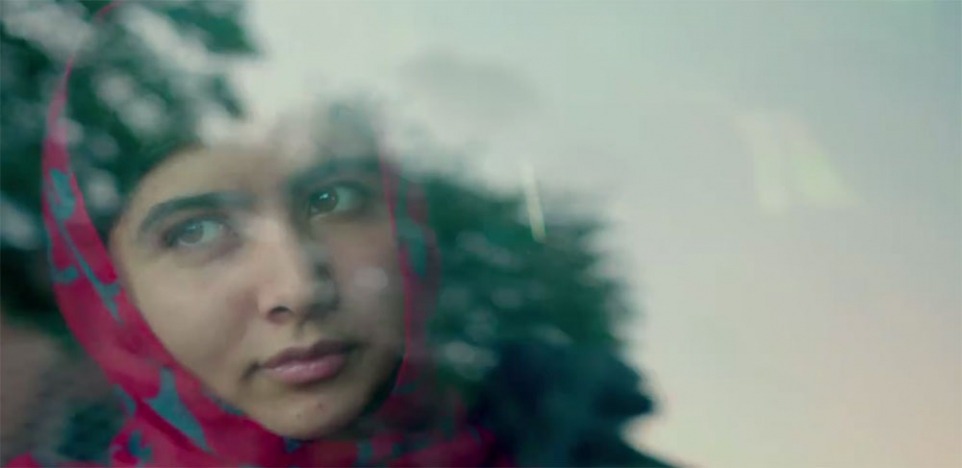 a young woman in a burqa looks through a car window