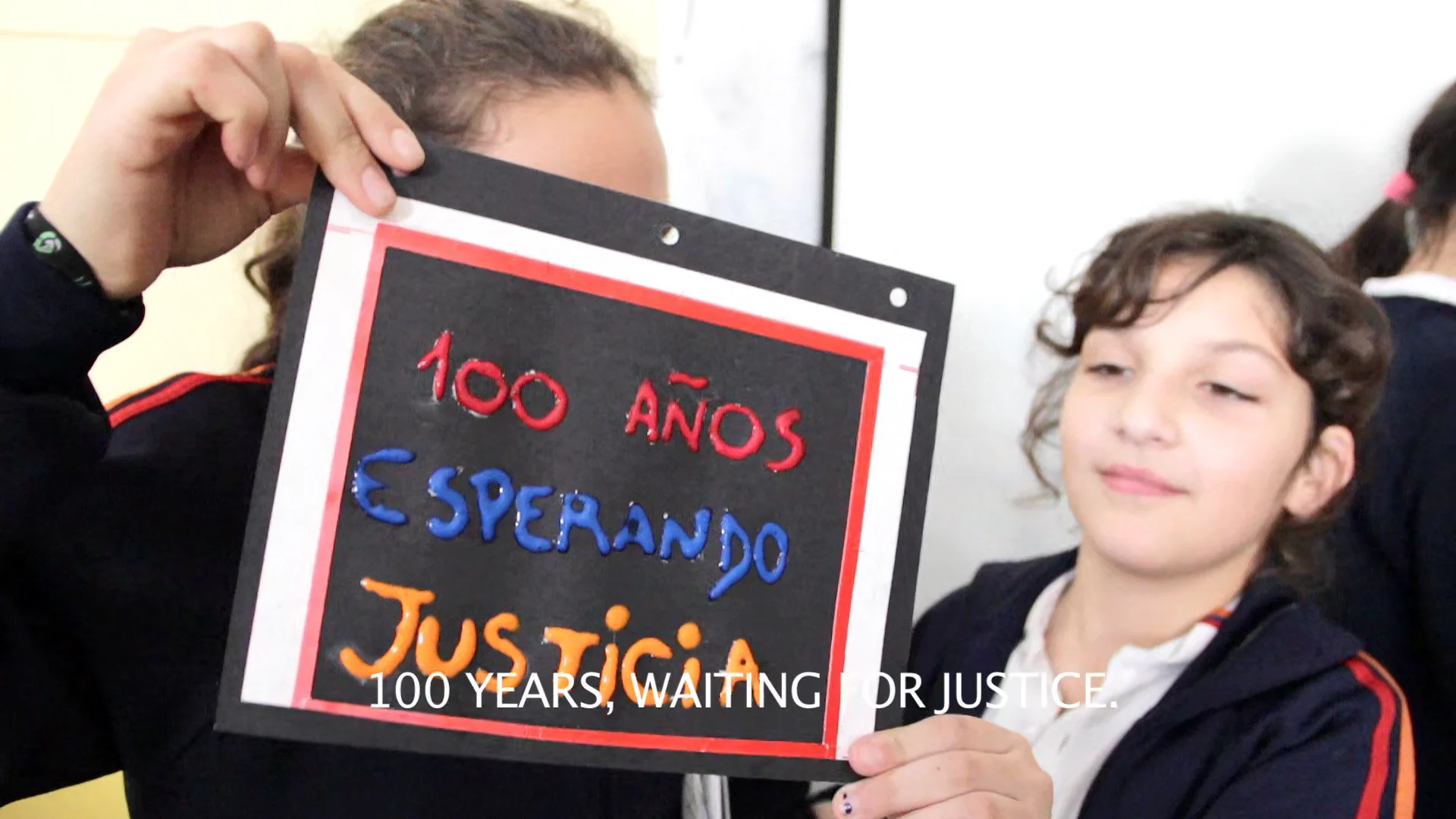 a young black-haired student shows a blackboard