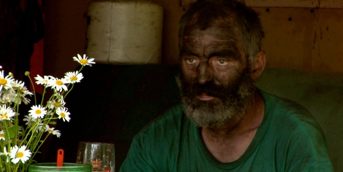 man stained with charcoal all over his face