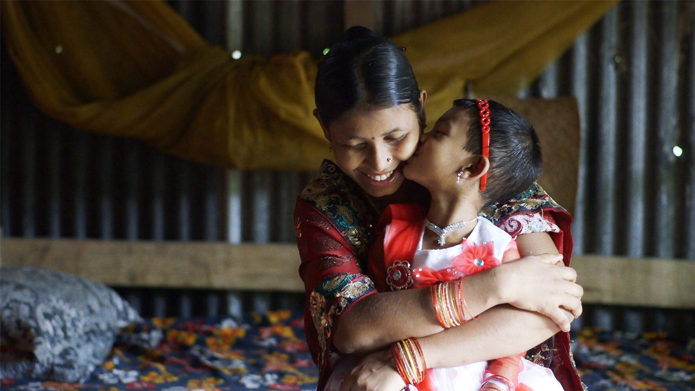 two girls hug each other