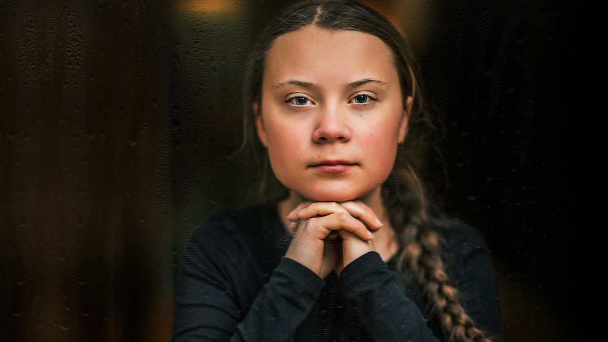 a girl poses on a dark background