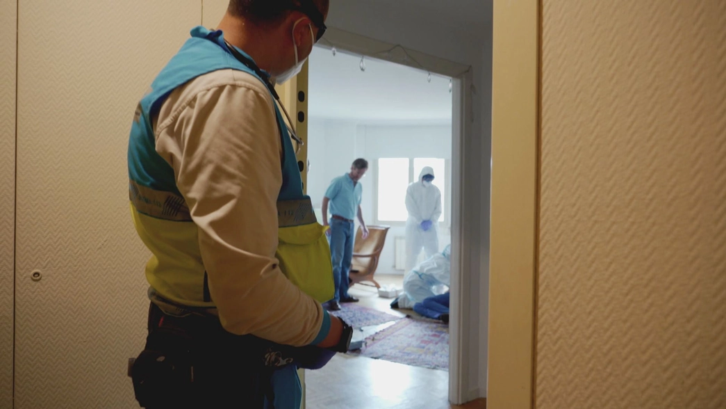 specialists behind a door, all wearing masks