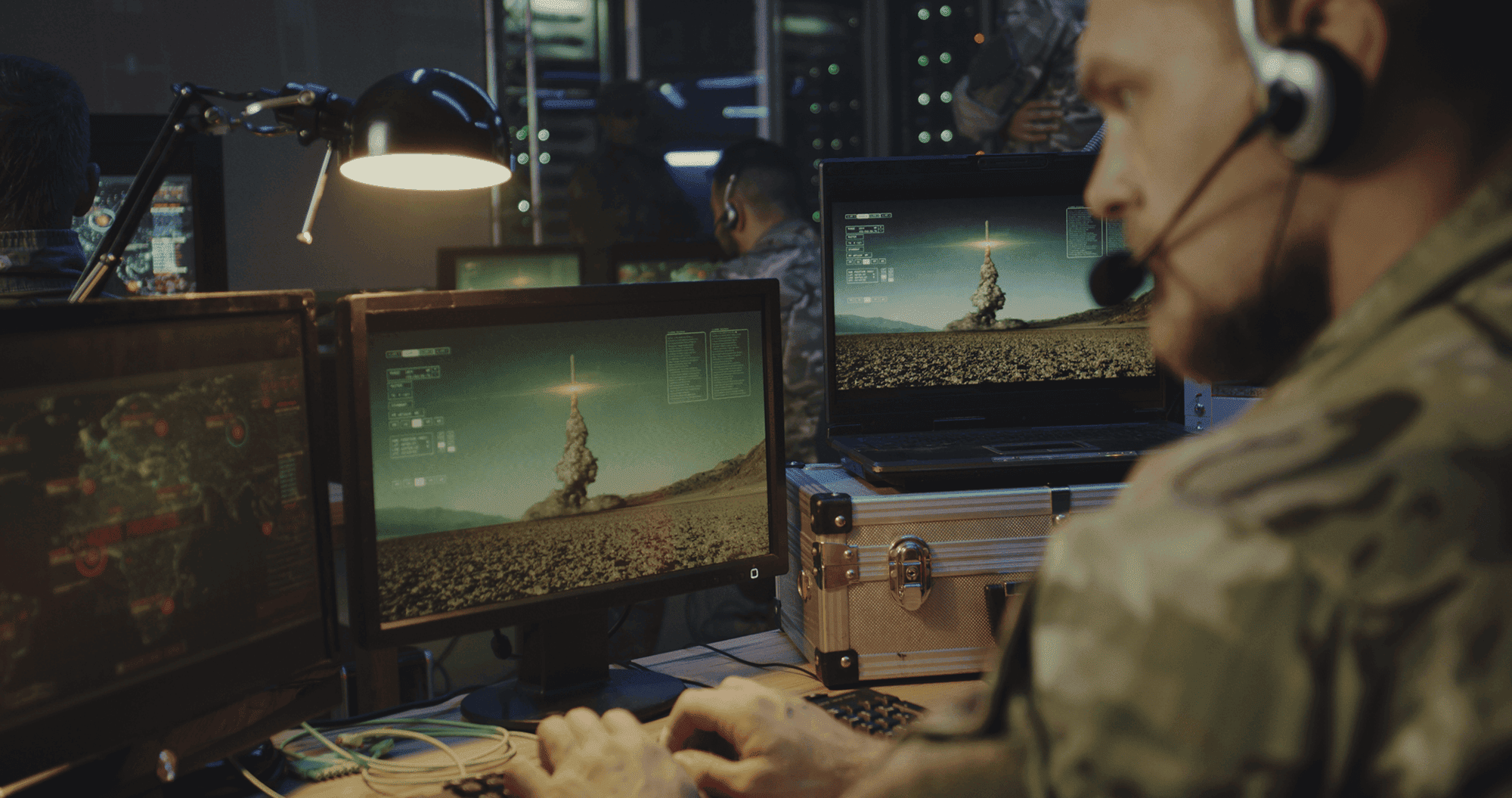 bearded soldier in front of computer screens