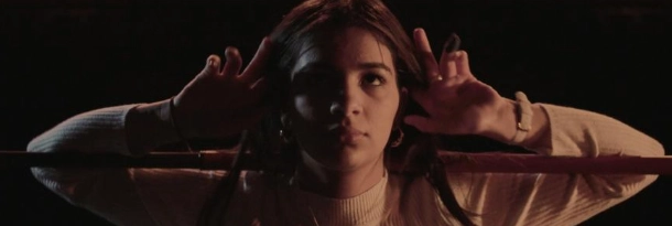 a girl with her hands near her ears