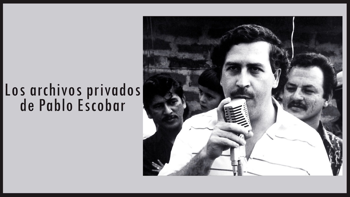 dark-haired man with a mustache at the microphone