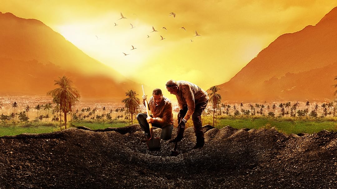 Two male explorers fit in the middle of a wasteland surrounded by mountains