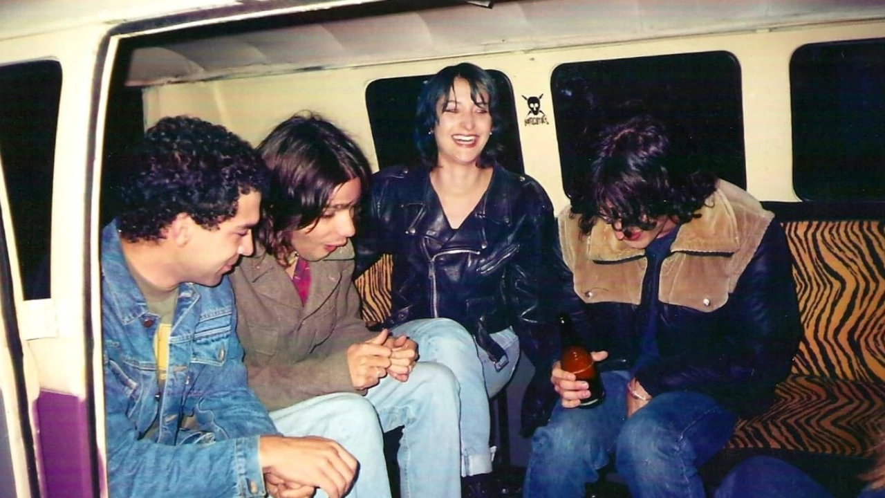 A group of young people inside a van having fun
