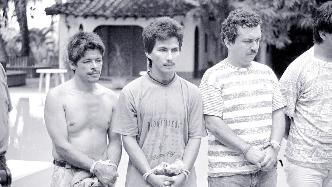 three men with mustaches and their arms tied