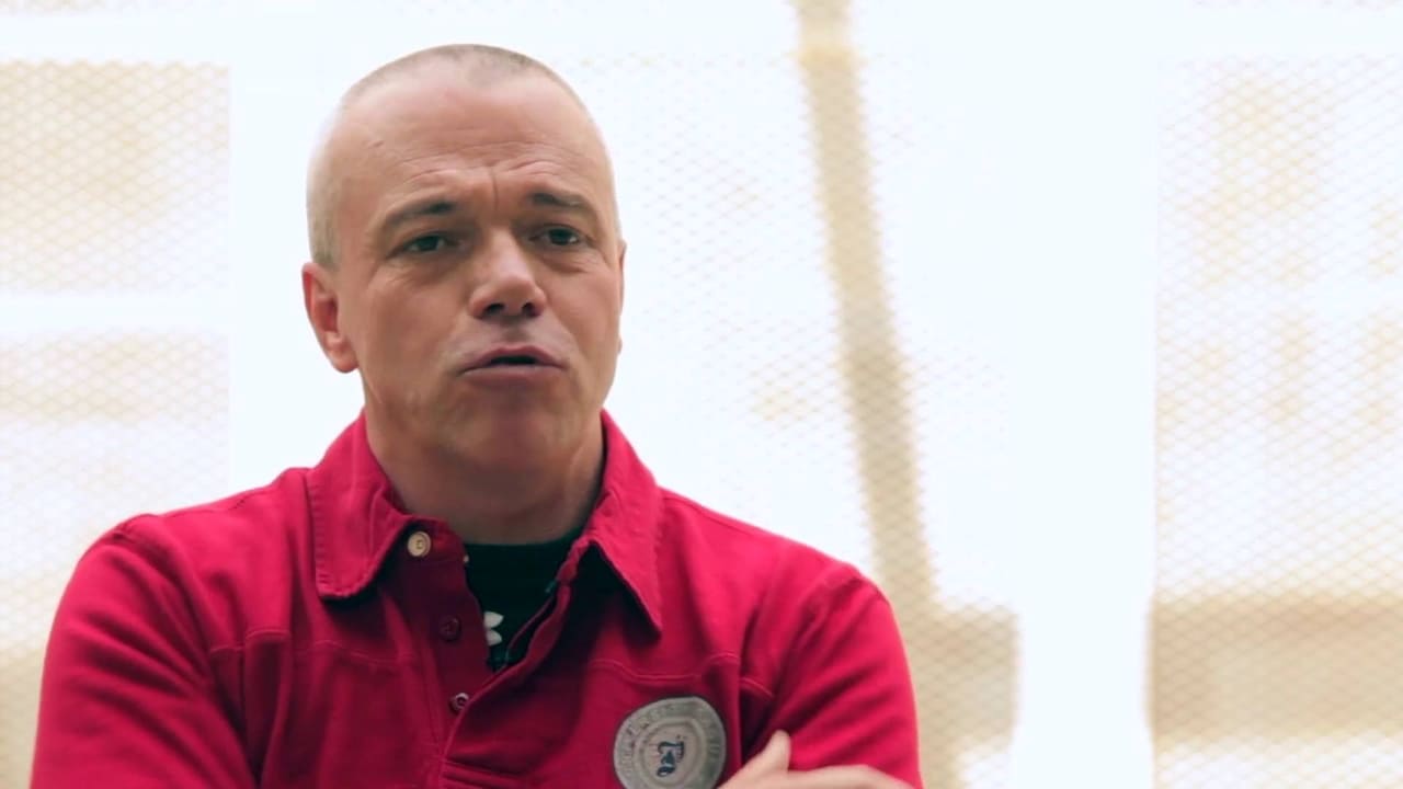 man with short gray hair and a red shirt