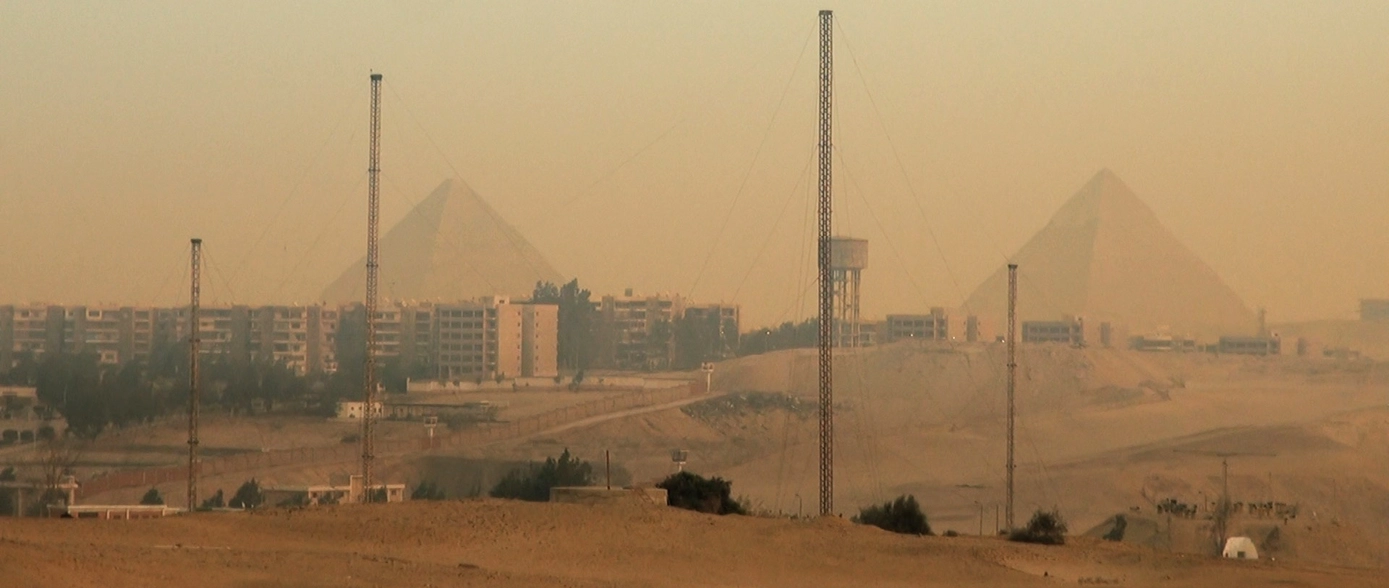 the pyramids in the background and the city of Cairo